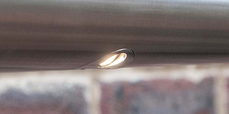 RAILled Asymmetric Handrail Lighting in front of a brick wall